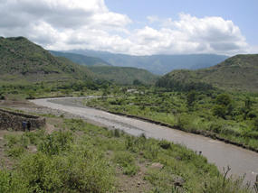 High proportion of suspended sediment load in the Gina river as indicated by the colour of the water