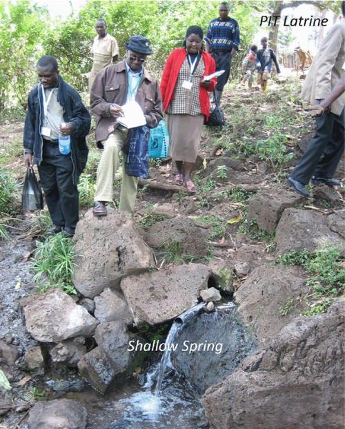 PIT latrine next to shallow spring