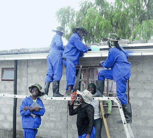 Local trainees preparing a roof for rainwater harvesting